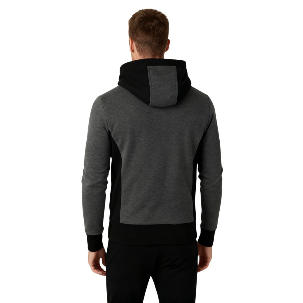 Person wearing a dark gray kouvr hoodie with black accents on a white background