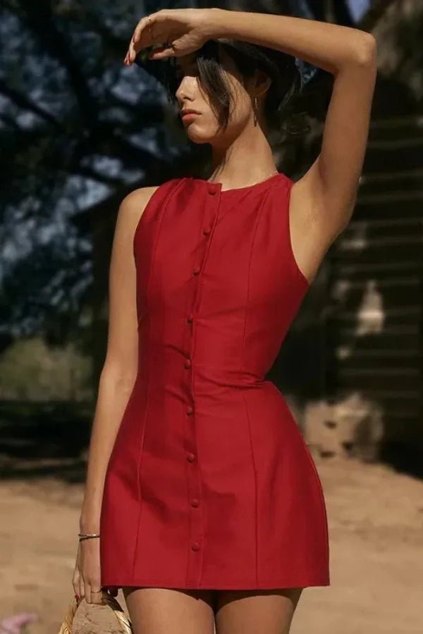 Model wearing the Kouvr Cosette sleeveless red mini dress in a rustic setting