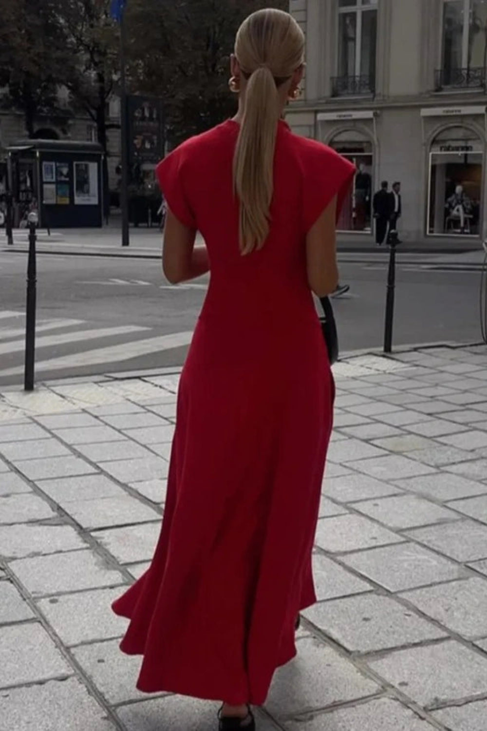 sculptural silhouette," "architectural design," "power dressing," "elegant," "crepe knit," and "wedding guest attire