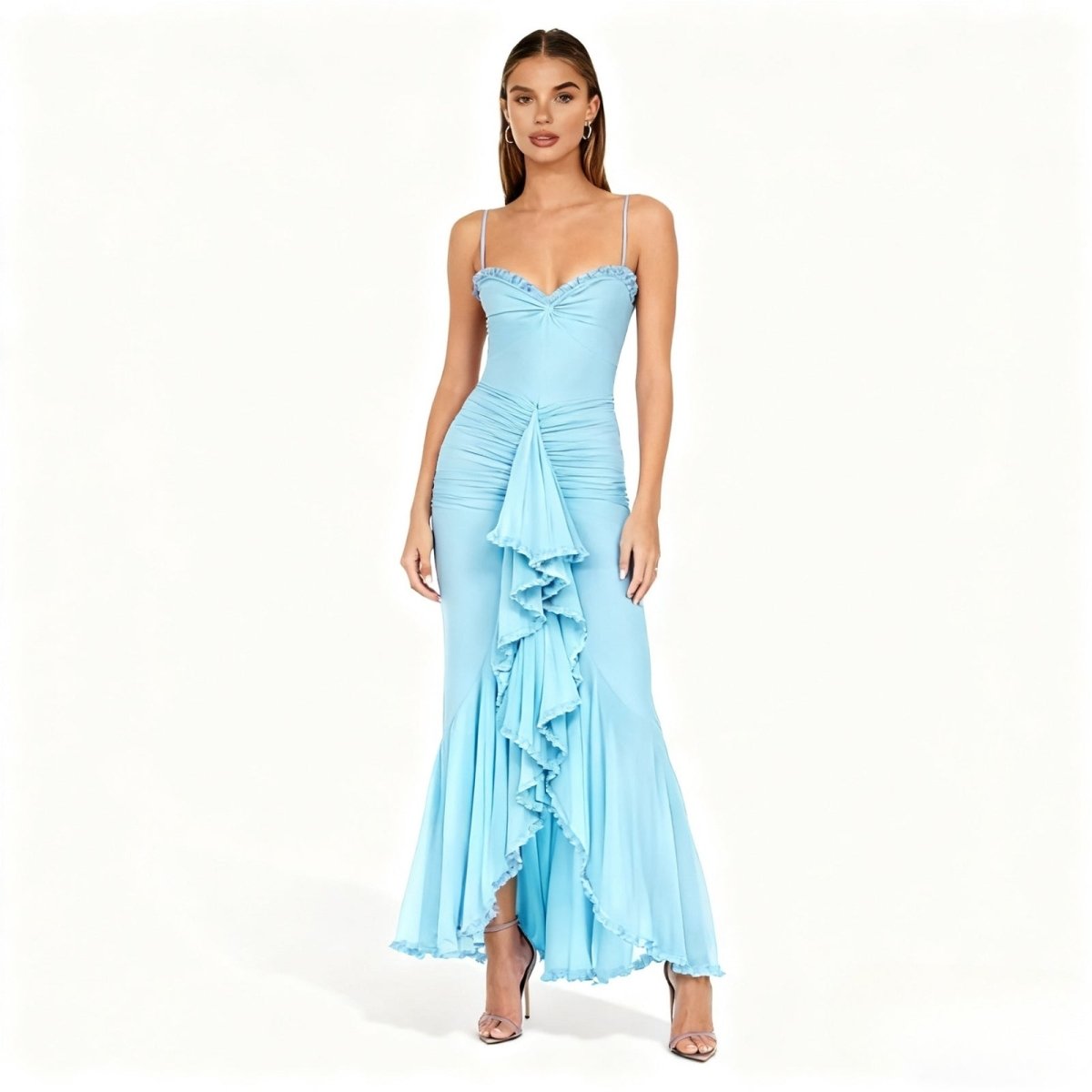 Woman wearing a light blue kouvr evening gown with ruffled details on a white background