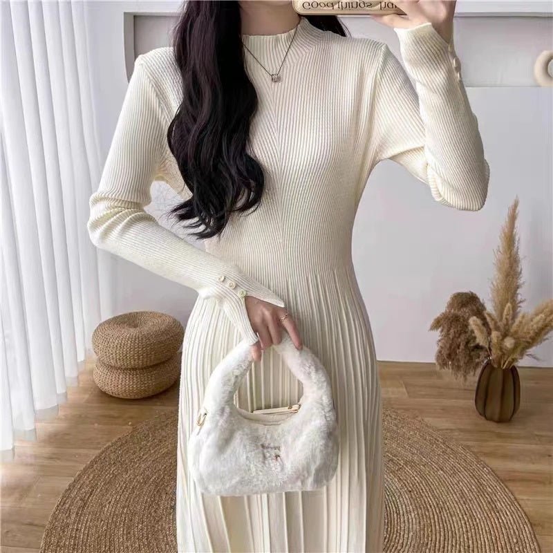 Close-up view of the ribbed knit texture and button cuff details on the ivory Dannah midi dress from Kouvr Fashion.