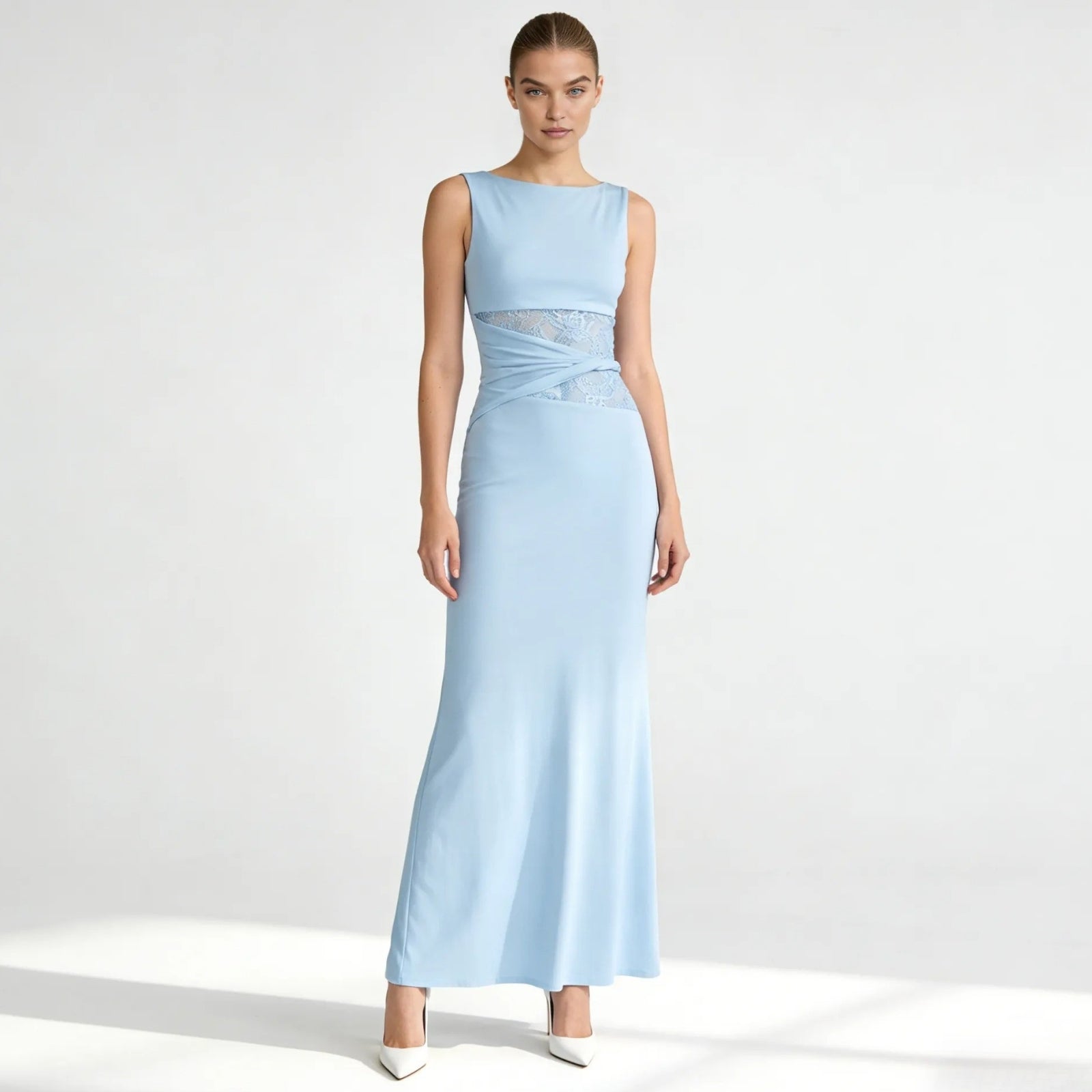 Model wearing the Kouvr Fashion Deborah Gown in light blue, showing the front view with bateau neckline and asymmetric lace waist detail.