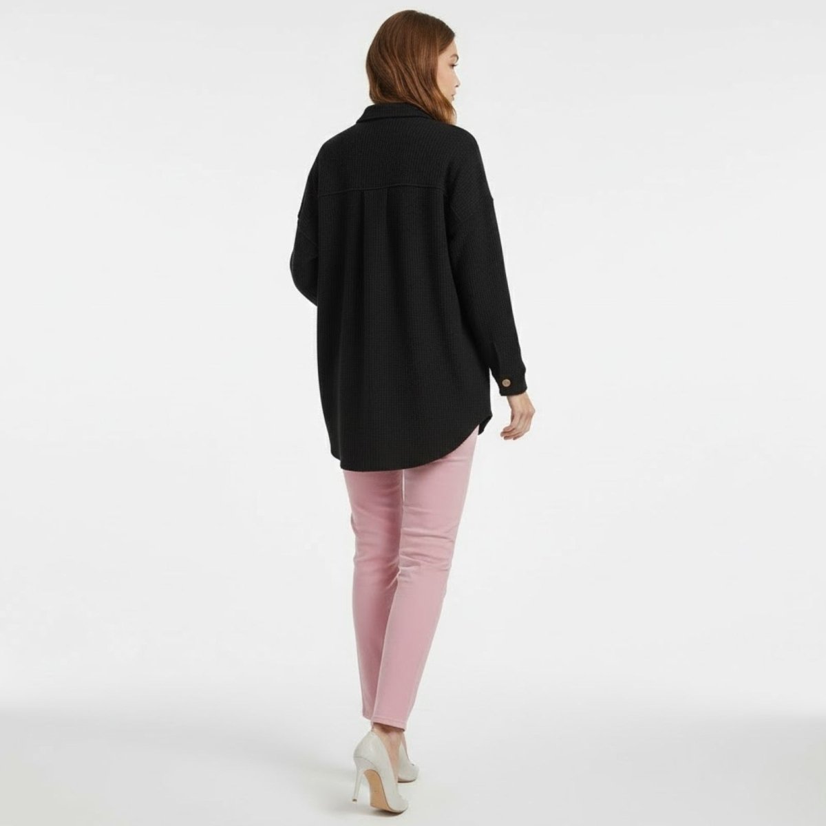 Back view of a woman walking away wearing the black Donna Waffle Knit Shacket, showing the back yoke and overall length.