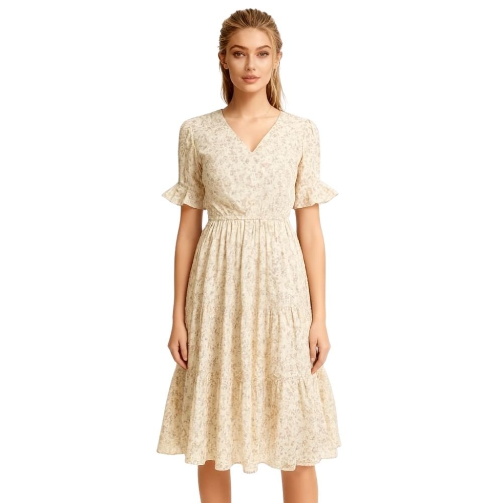 Woman wearing a kouvr beige floral dress on a white background