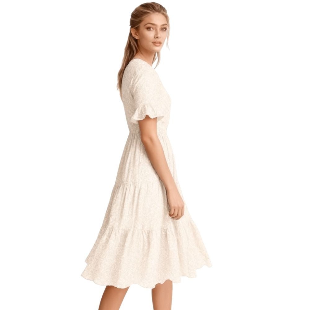 Woman wearing a kouvr beige dress on a white background