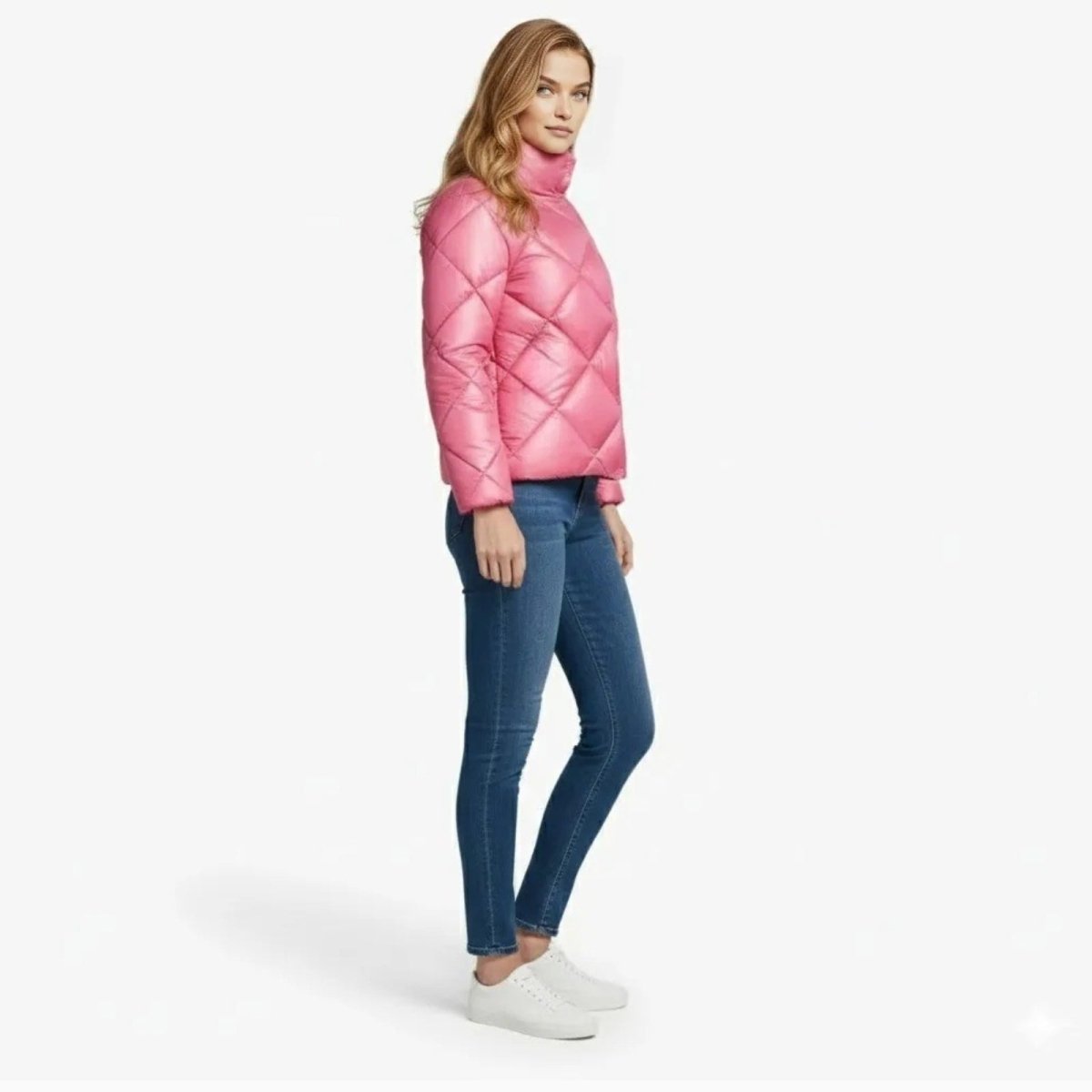 Side view of a model in the Kouvr Fashion Elisse Puffer Jacket in pink, showing the jacket's waist-length silhouette and quilted texture.