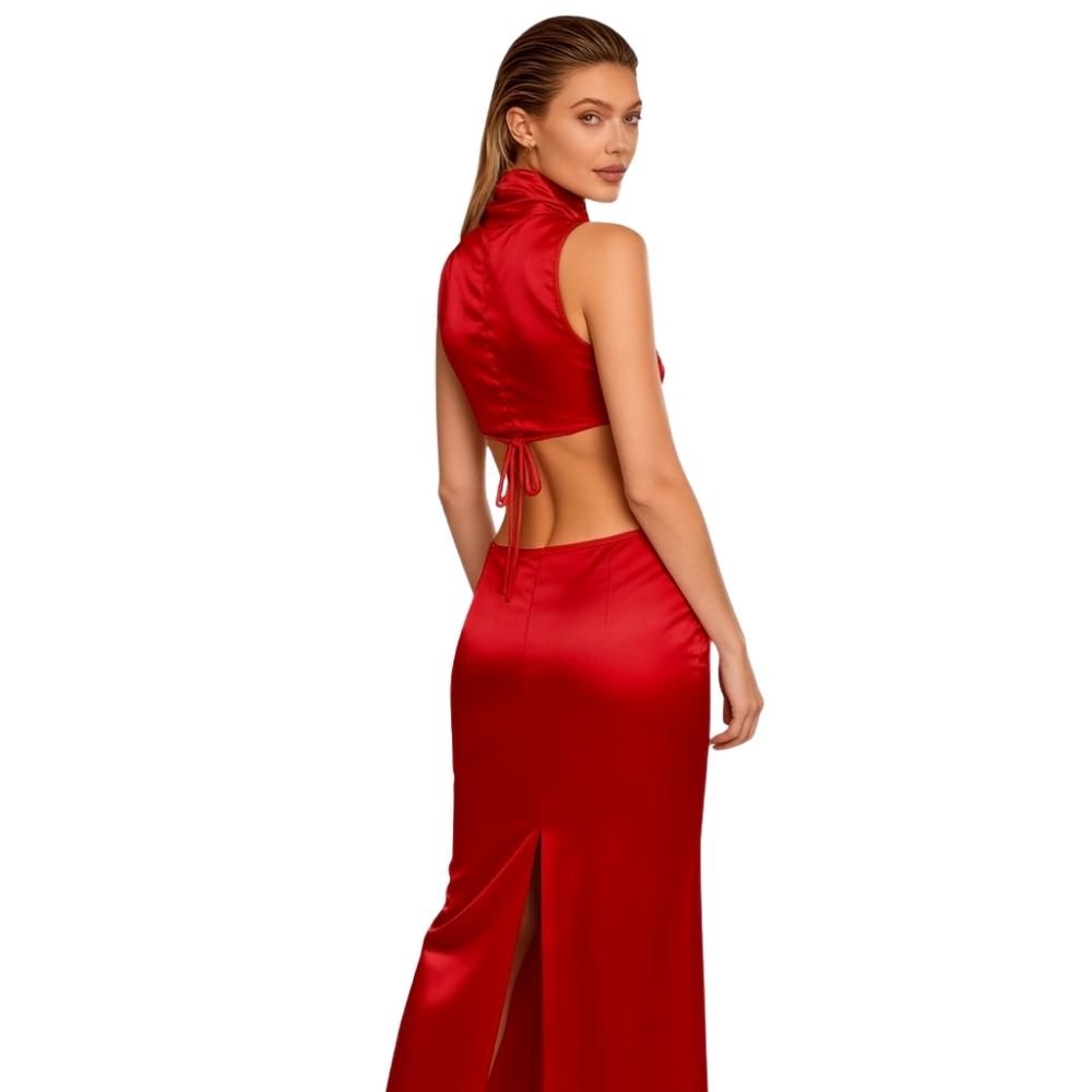 Woman wearing a red kouvr satin dress with a backless design on a white background