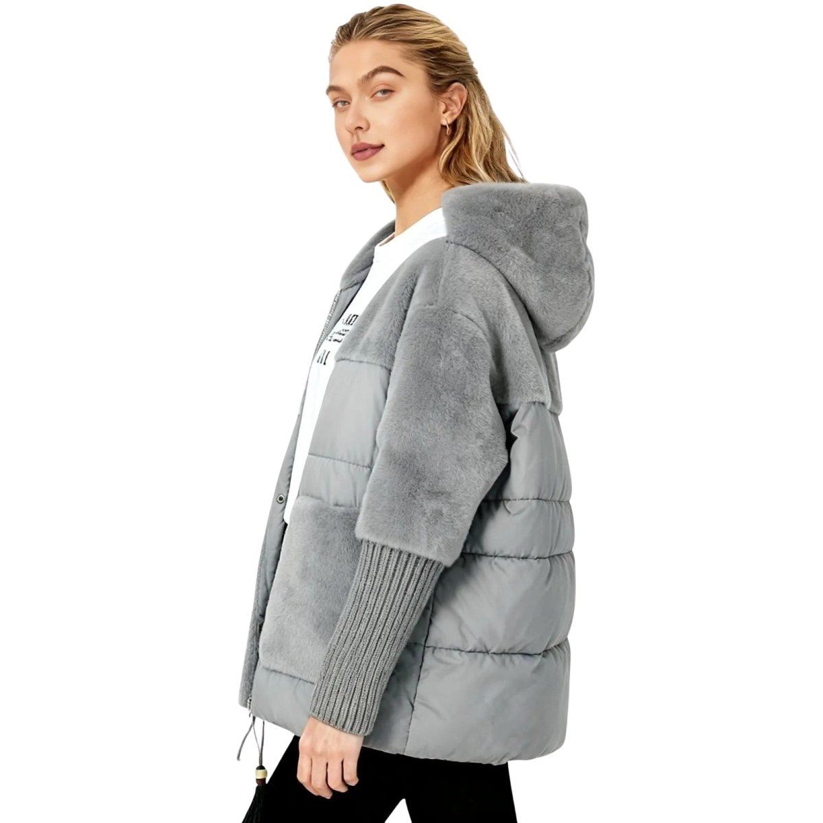 Woman wearing a gray kouvr puffer jacket on a white background