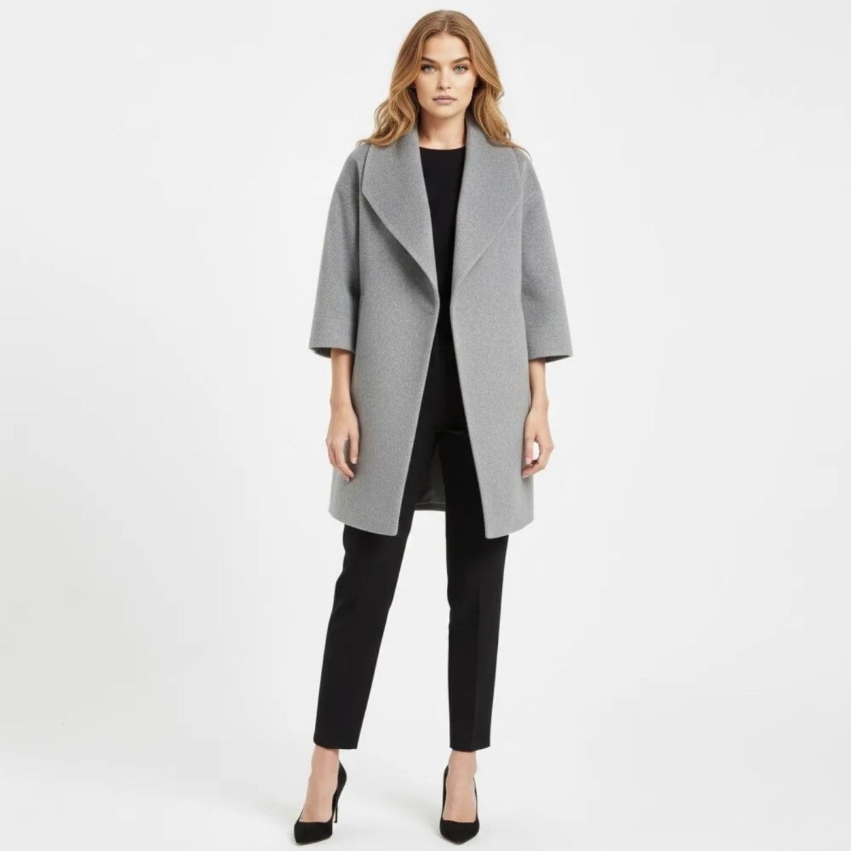 Model facing forward wearing the Kouvr Fashion gray wool blend shawl collar cocoon coat with black trousers and heels.