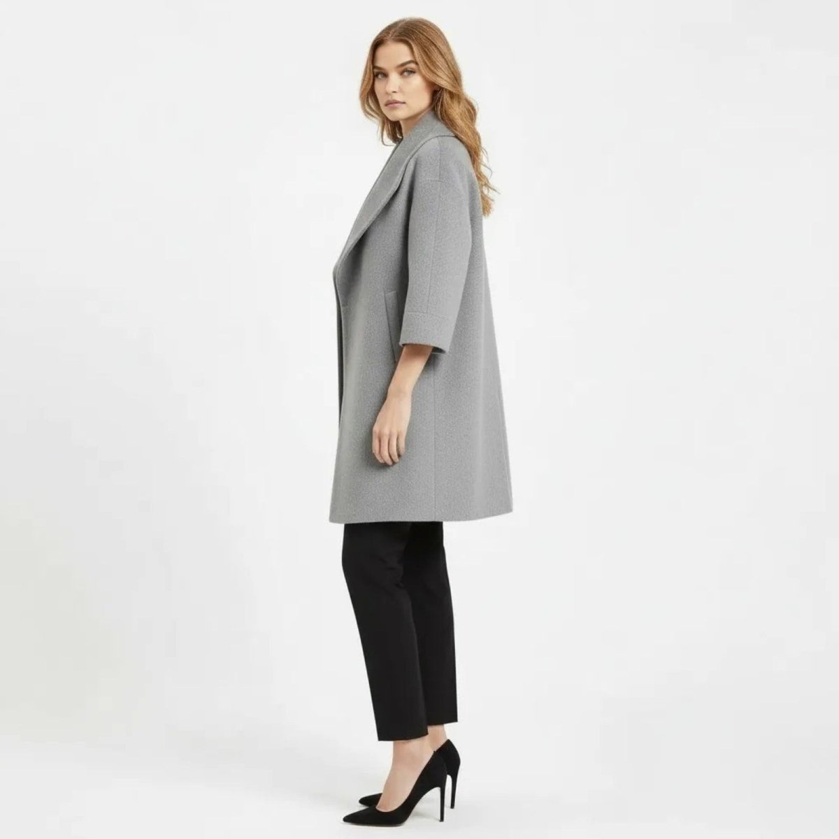 Model in a side profile view showcasing the drape and silhouette of the Kouvr Fashion gray open-front cocoon coat.