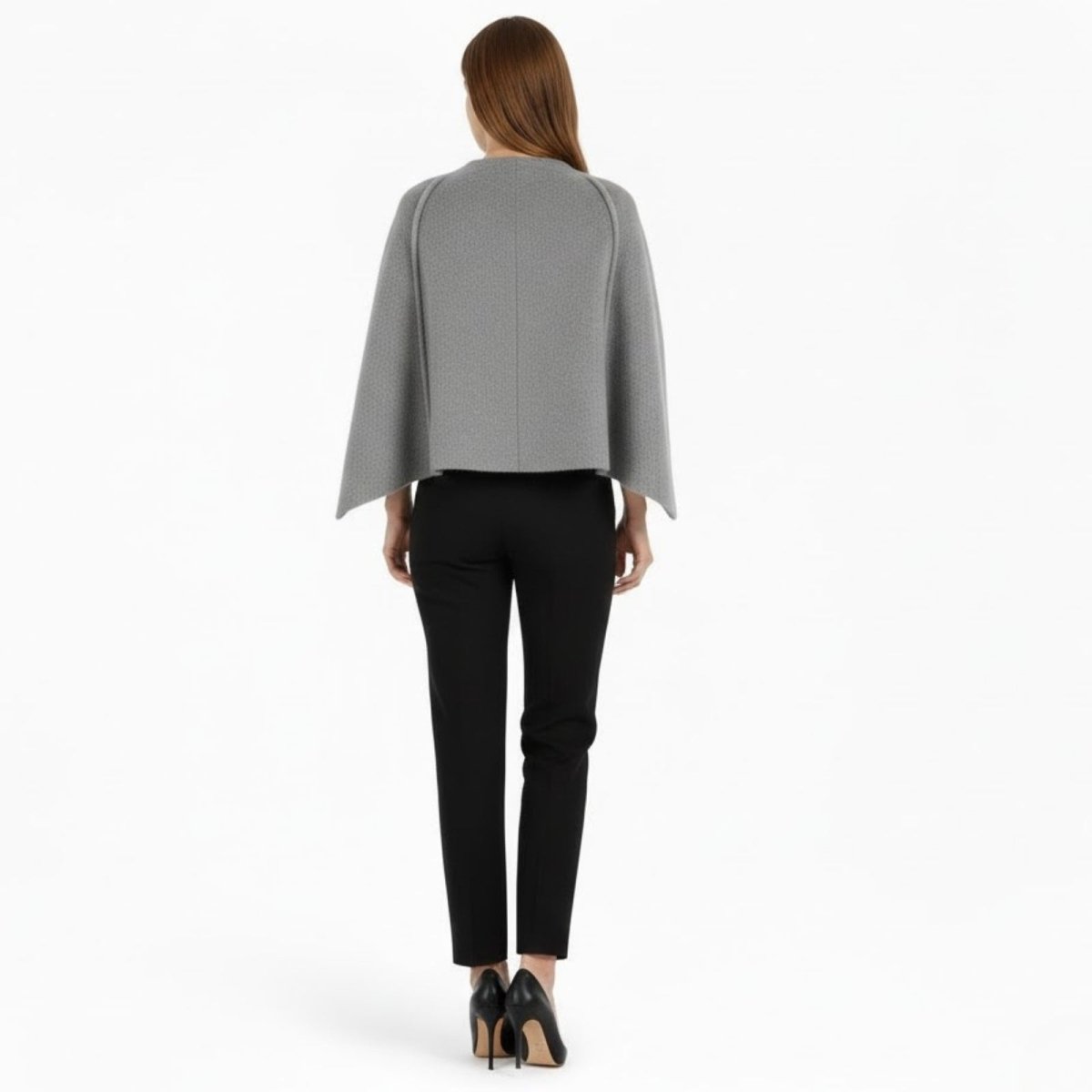 Back view of a model wearing the Kouvr Fashion grey wool-blend cape, showing the clean lines and center seam detail.