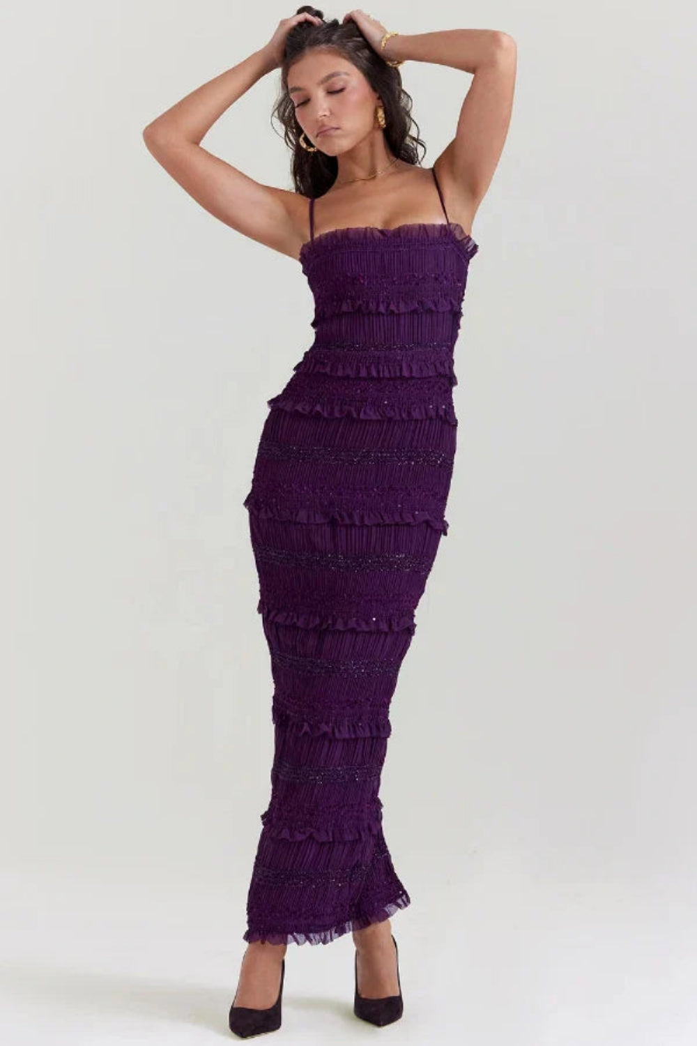 Model wearing the Kouvr Fashion Hannie formal evening jumpsuit in plum purple with tiered ruffles and bead embellishments