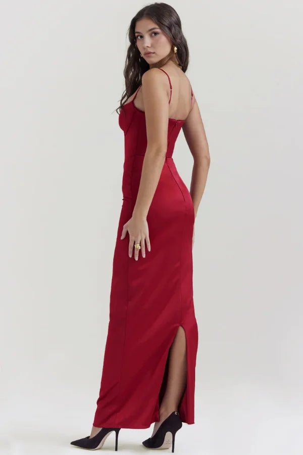 Three-quarter back view of the red Haven satin corset gown, showing the rear slit for movement and the bodycon fit.
