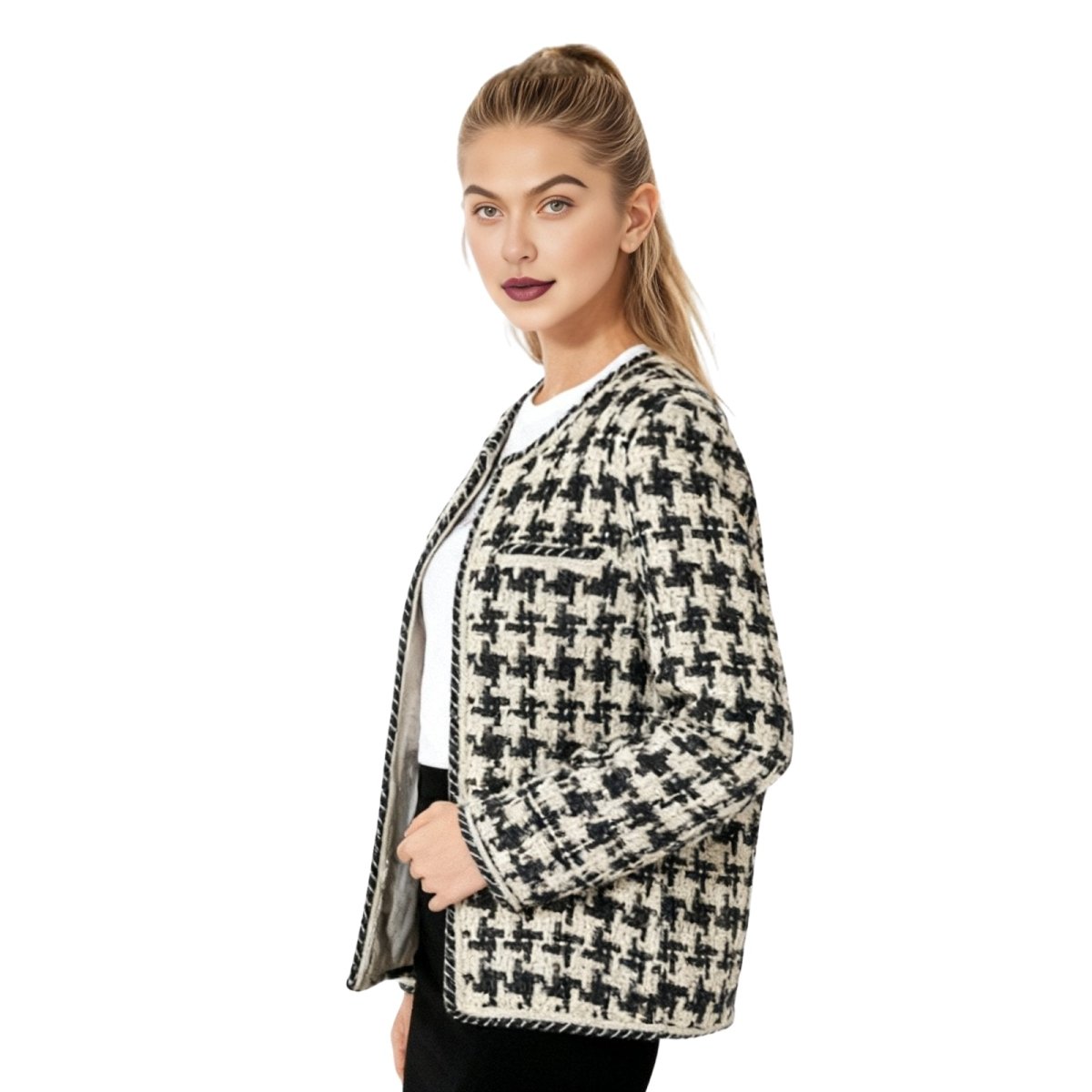 Woman wearing a houndstooth patterned jacket on a white kouvr background