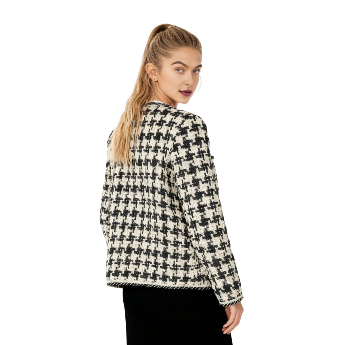 Woman wearing a black and white kouvr checkered jacket on a white background