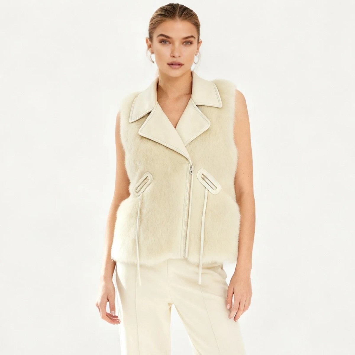 Woman wearing a Ivory Kouvr sleeveless jacket on a white background