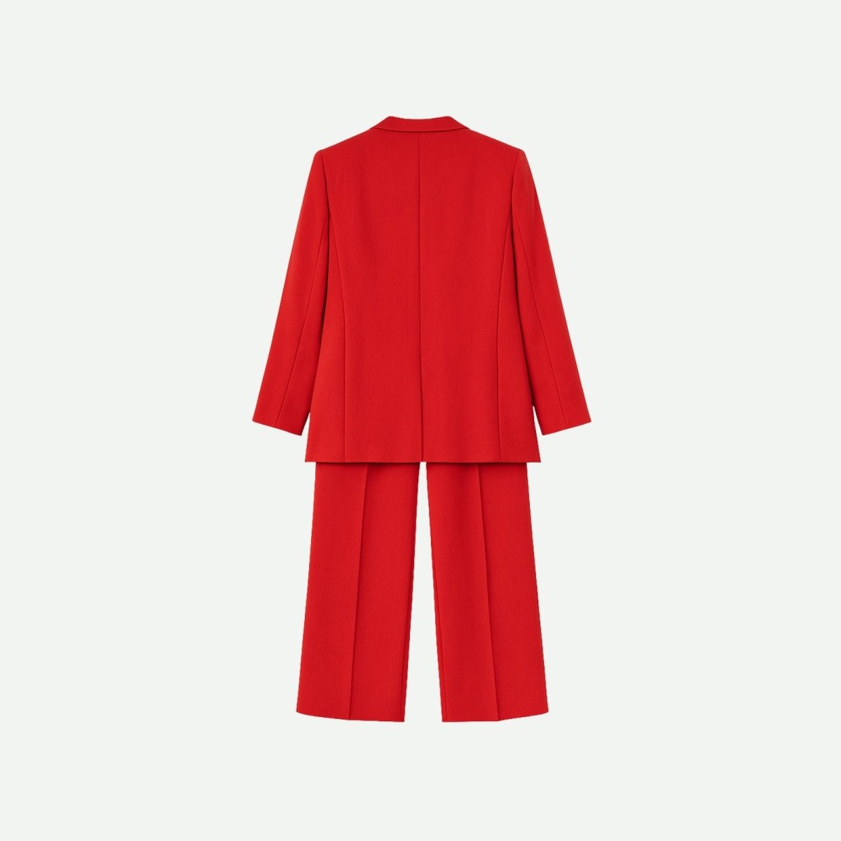 Flat lay of the back of a red women's suit, detailing the construction of the blazer and trousers against a white background.