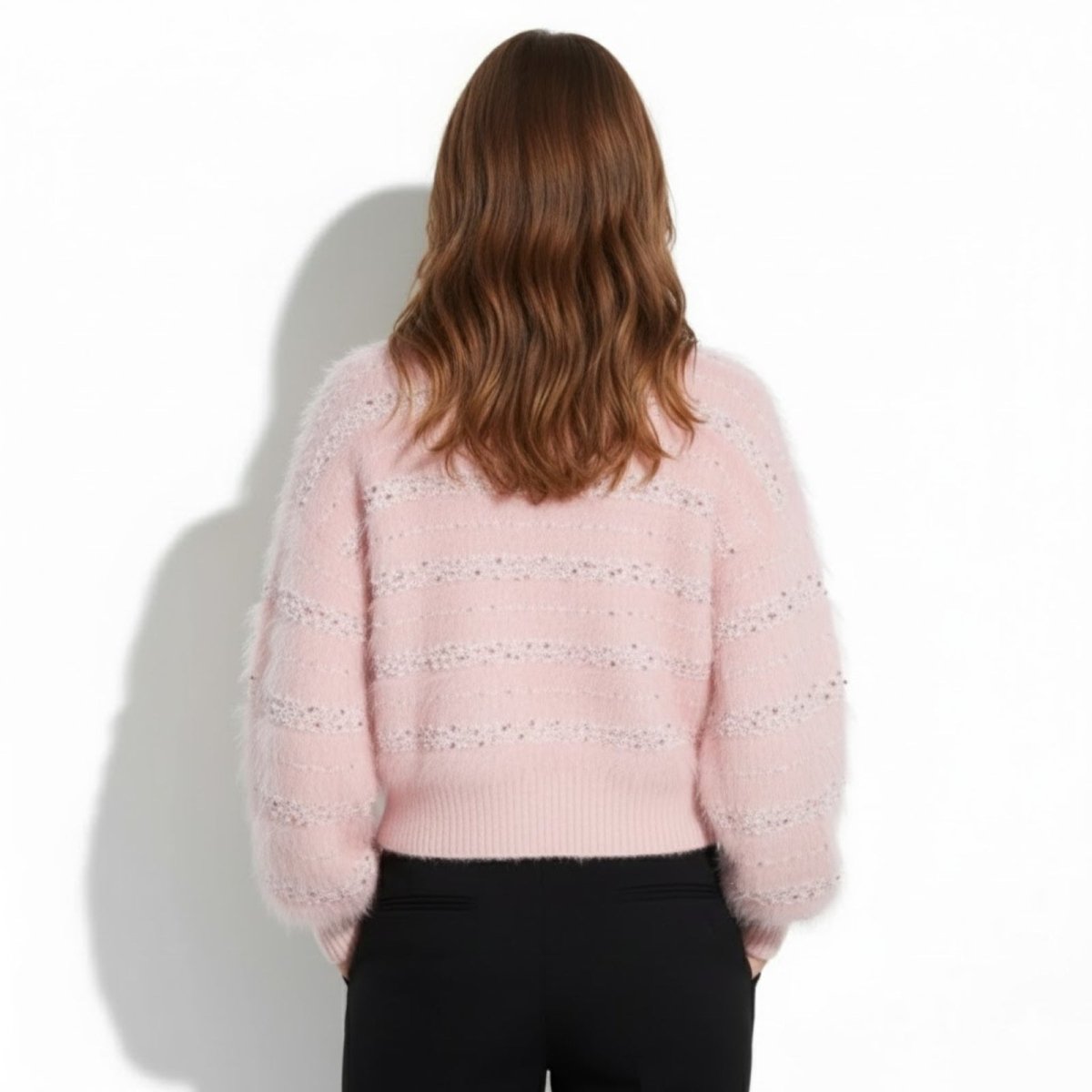 Back view of the Kyra pink fuzzy cardigan highlighting the textured sequin stripes and soft knit.