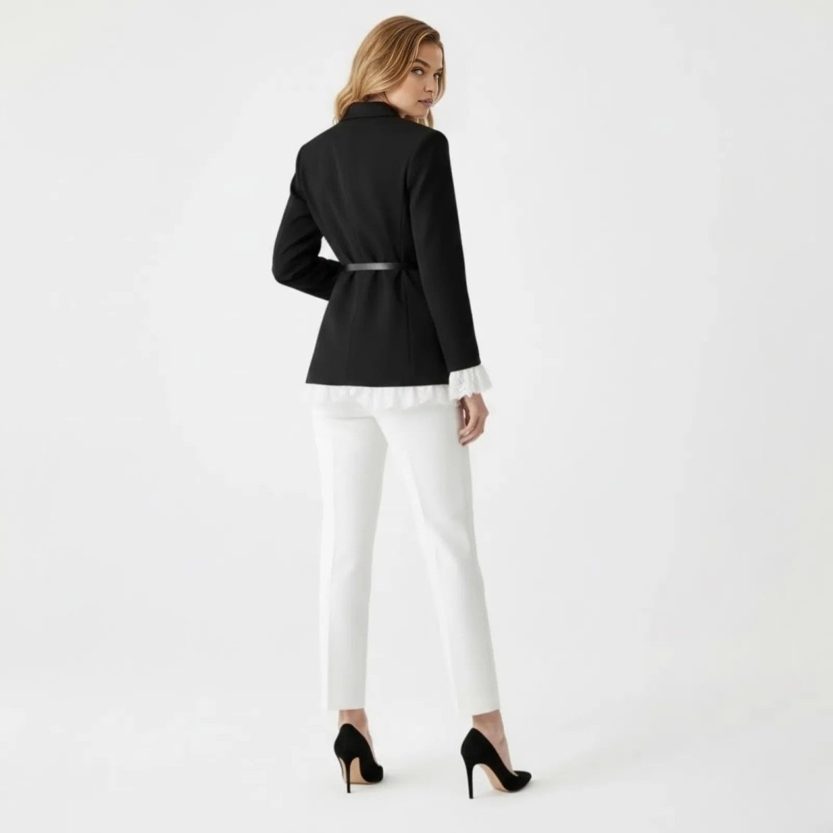 Back view of a model wearing the Kouvr Fashion black blazer, showing the fit of the belt and the clean lines of the tailoring.