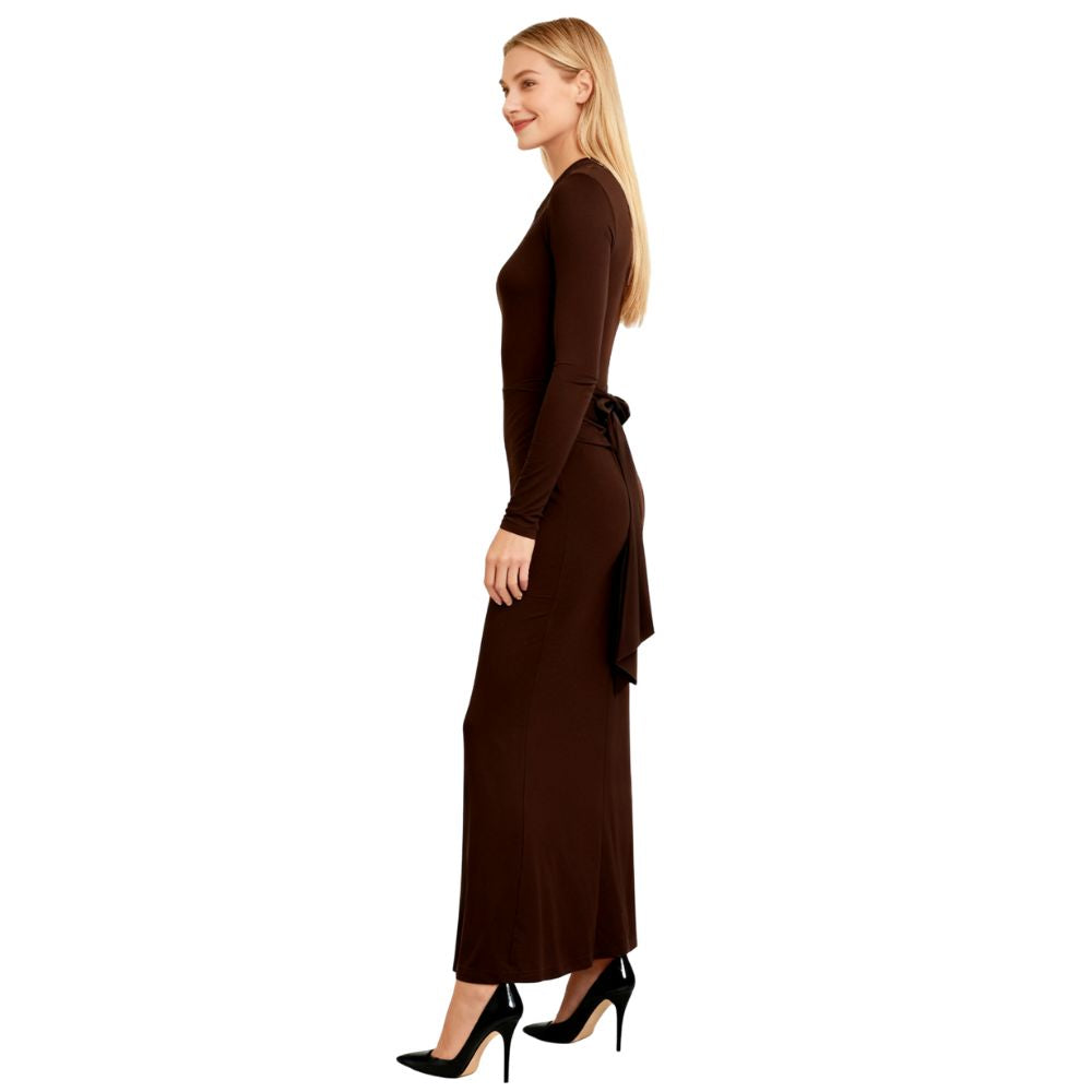Woman wearing a dark brown kouvr dress on a white background