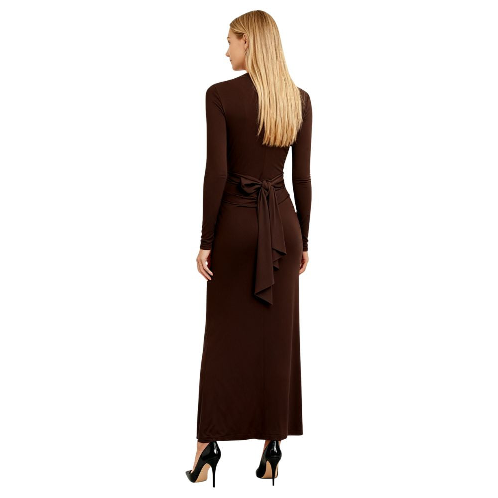 Woman wearing a dark brown kouvr  long-sleeve dress with a belt on a white background