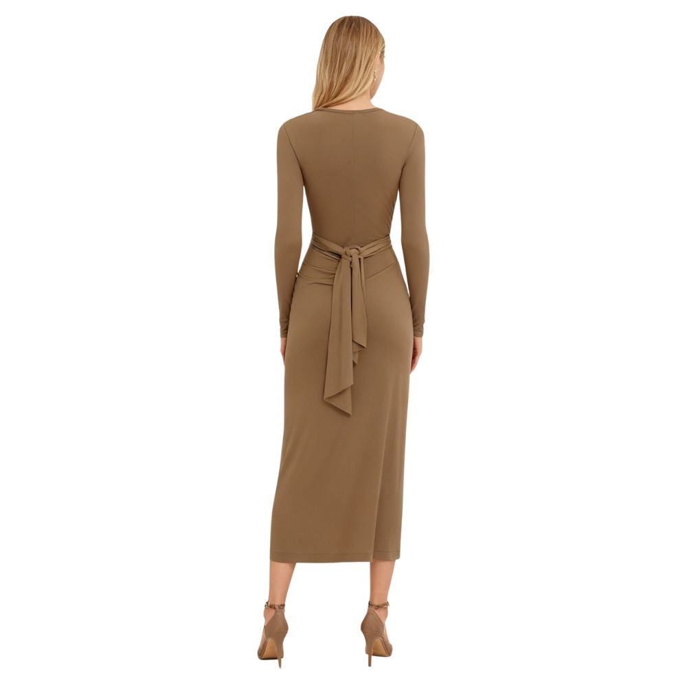 Woman wearing a khaki kouvr dress with a belt on a white background