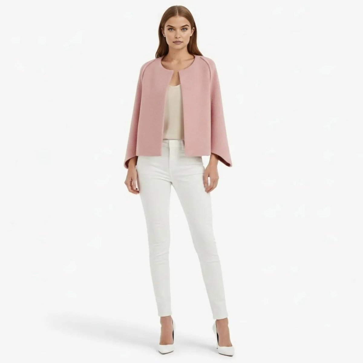Model wearing the Kouvr Fashion Laverne collarless cropped jacket in pink, styled with white pants and heels, front view.