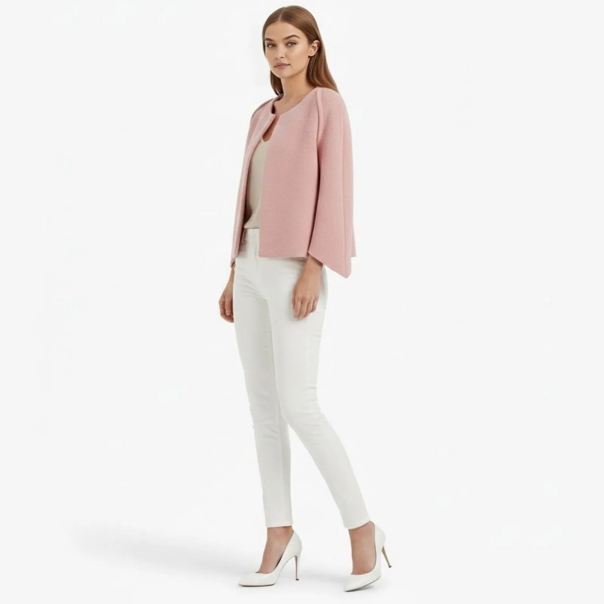 Side profile of a model in a structured pink bell sleeve jacket from Kouvr Fashion, showcasing the elegant silhouette.