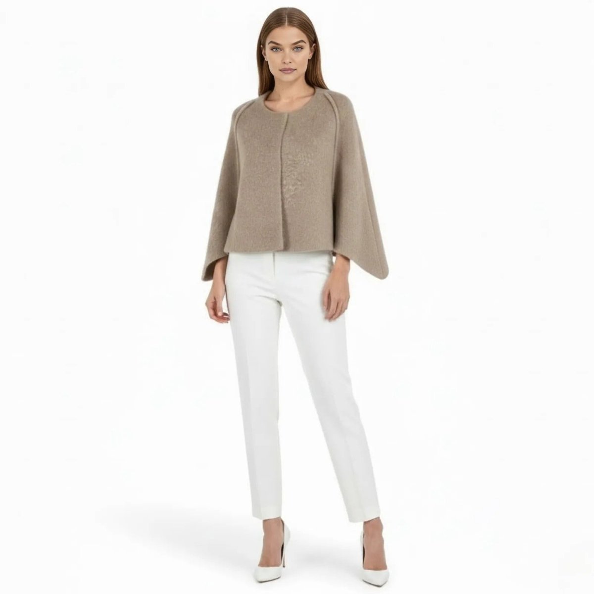 Model wearing the Laverne Khaki wool cape jacket from the front, styled with white trousers. A minimalist short coat with bell sleeves by Kouvr Fashion.