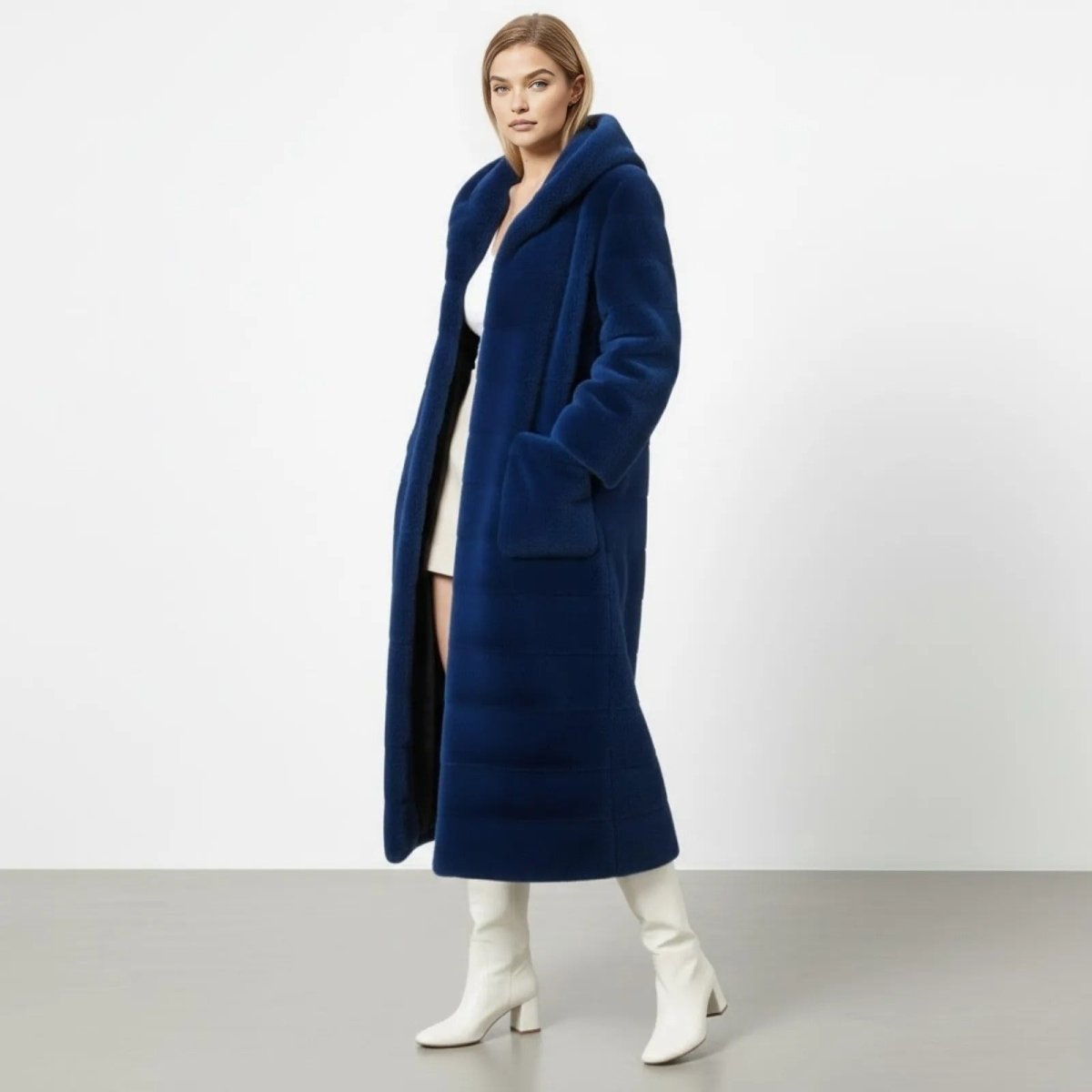 Side angle view of a model in the Luisa royal blue maxi faux fur coat, showcasing its length and plush texture.