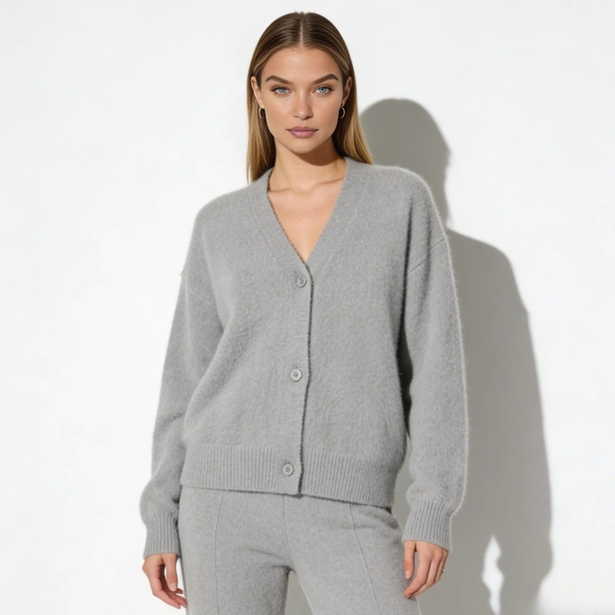 Model wearing the Kouvr Fashion luxe alpaca v-neck cardigan in heather grey, facing front.