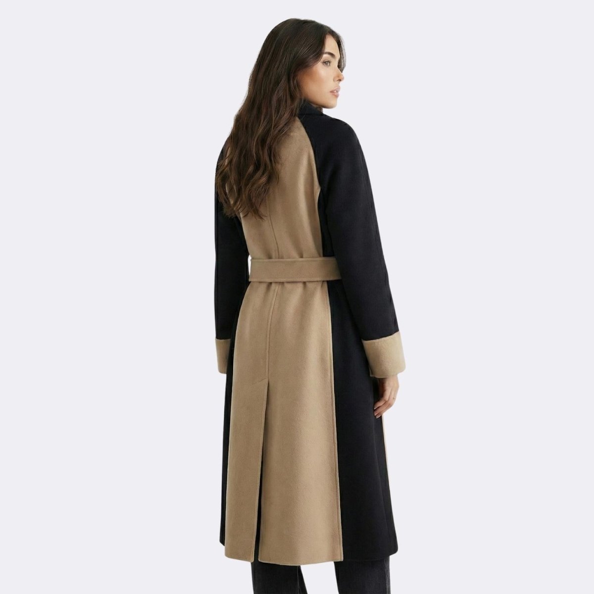 Back view of the Kouvr Fashion Madison color-block wool coat, highlighting the black raglan sleeves and central camel panel with belt.