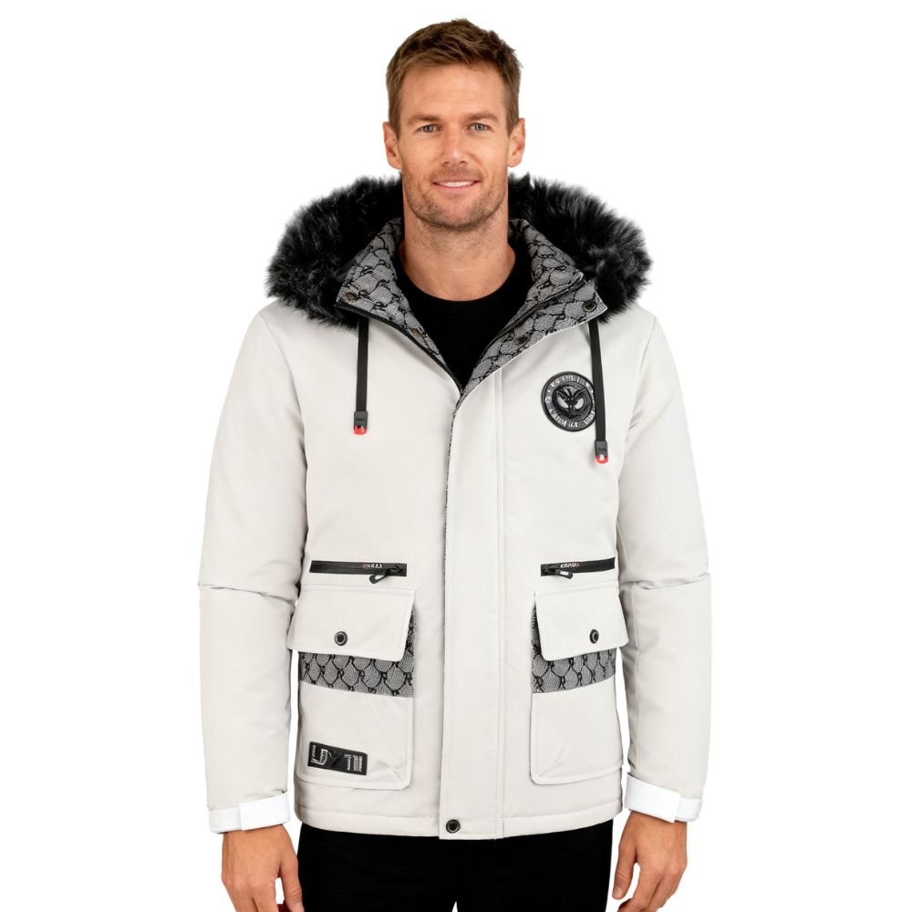 Man wearing a white kouvr winter jacket with fur hood on a white background