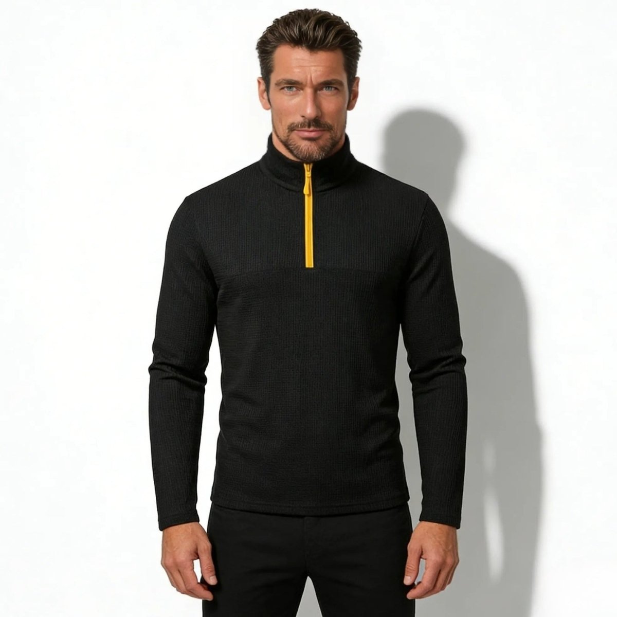 Male model wearing the Kouvr Fashion Onyx Performance Quarter-Zip Pullover in black with a yellow zipper, showing the slim athletic fit from the front.