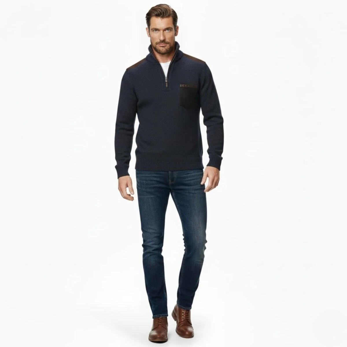 Man with a beard wearing the Kouvr Fashion navy blue quarter-zip sweater with dark shoulder patches and blue jeans, walking towards the camera.