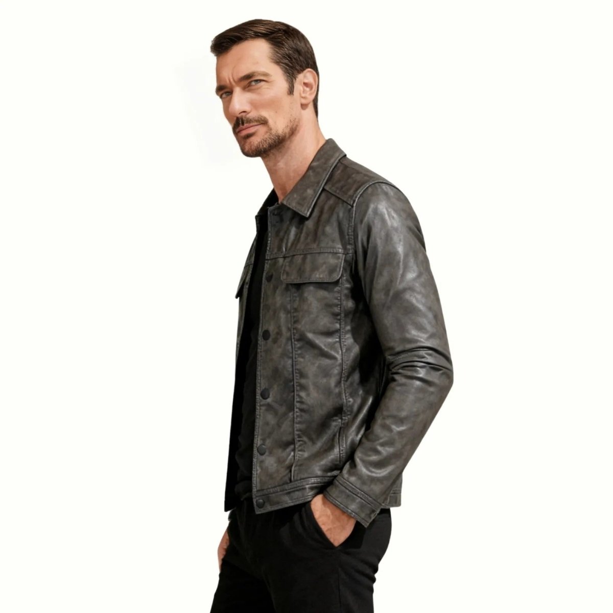 Side profile view of a man in a slim fit washed dark-grey designer leather jacket from Kouvr Fashion.
