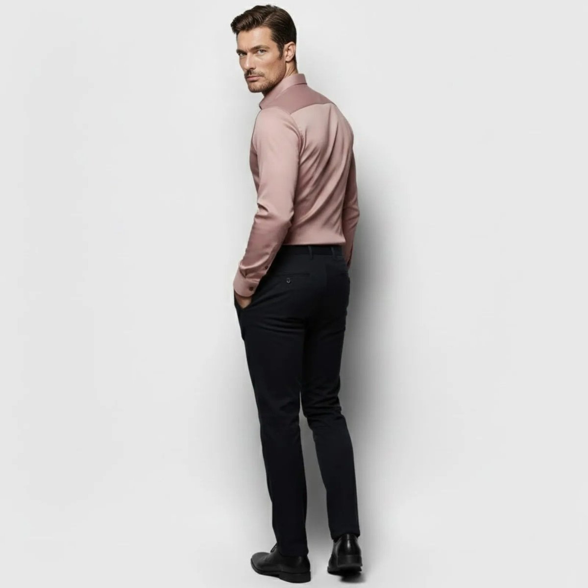 Back view of a male model in a slim fit sateen dress shirt in a sophisticated dusty rose color by Kouvr Fashion.