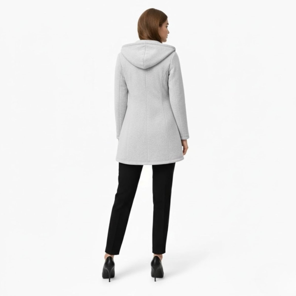Back view of a model in the Kouvr Fashion light grey hooded coat highlighting the structured seams and hood shape.