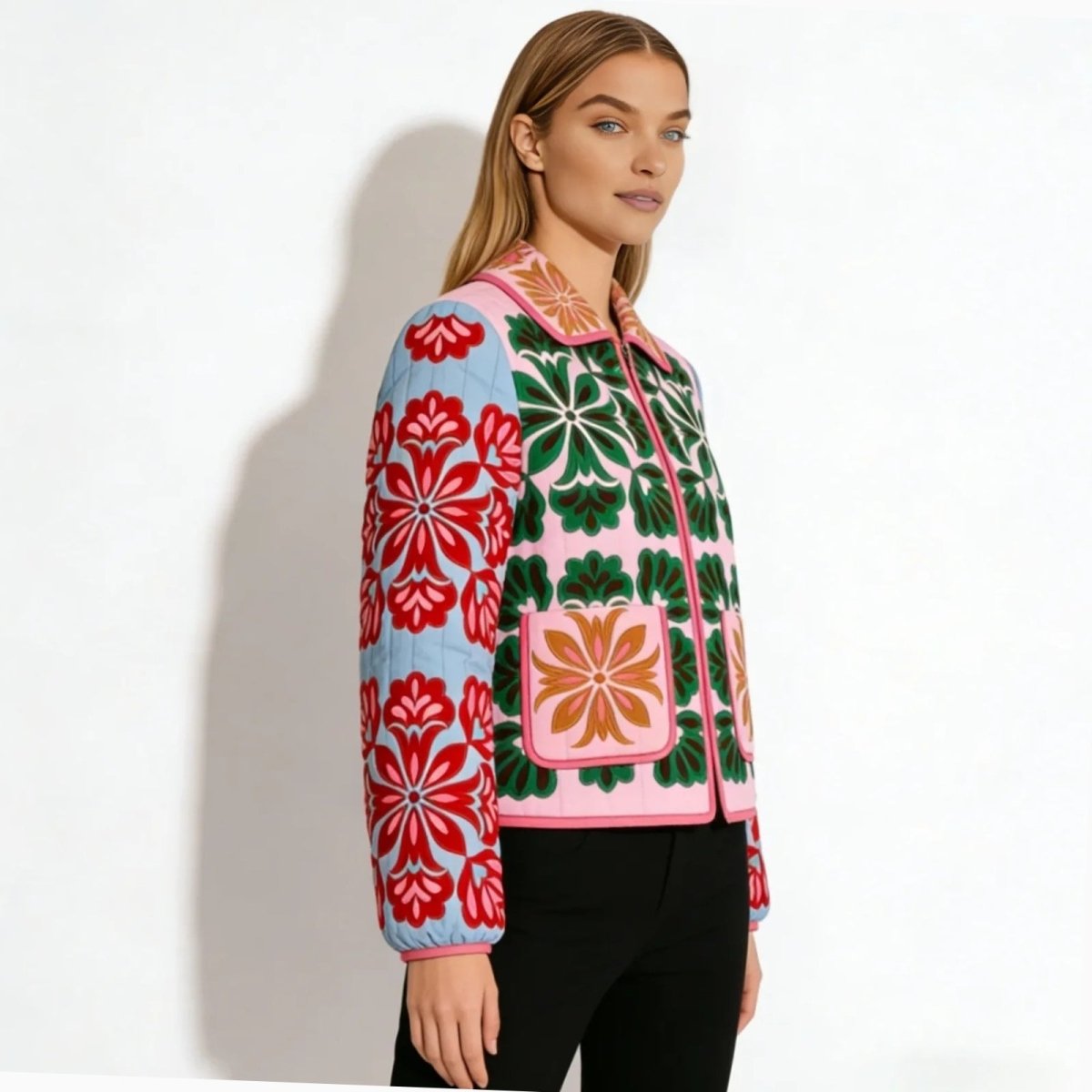 Side view of a woman wearing a colorful quilted floral jacket, showing the contrast between the pink body and the green, red-embroidered sleeves.