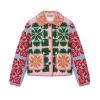 Flat lay of a pink and green quilted jacket showcasing the full floral embroidery design, collar, buttons, and patch pockets on a white background.