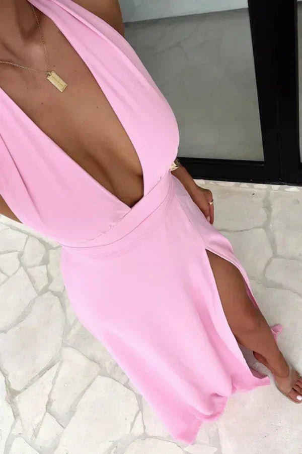 Model wearing the Kouvr Fashion pink backless halter neck maxi dress with a thigh-high slit, front view.' and 'Rear view of the Kouvr Fashion pink maxi dress showing the open back and tie details
