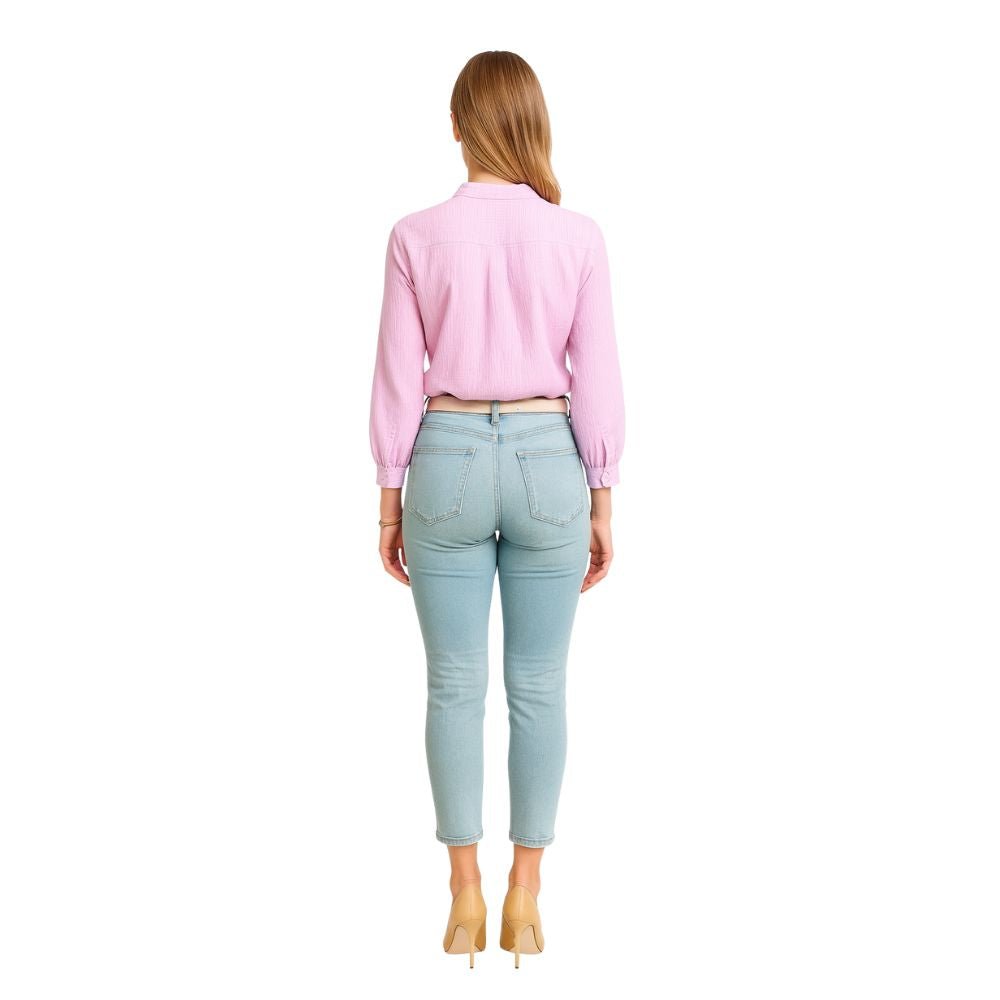 Model wearing the Kouvr women's white textured blouse with ruffle collar, paired with light wash jeans