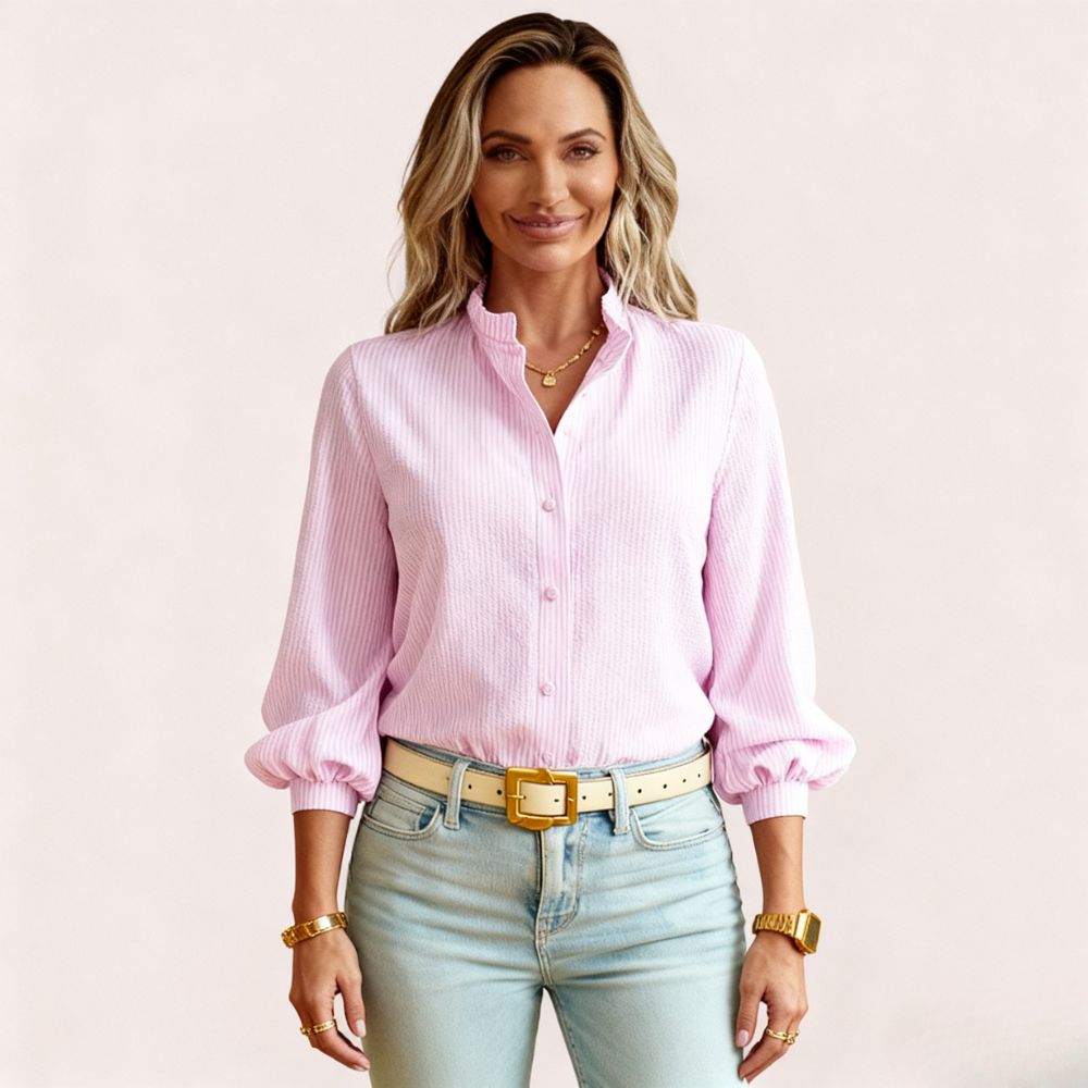 Model wearing the Kouvr women's white textured blouse with ruffle collar, paired with light wash jeans