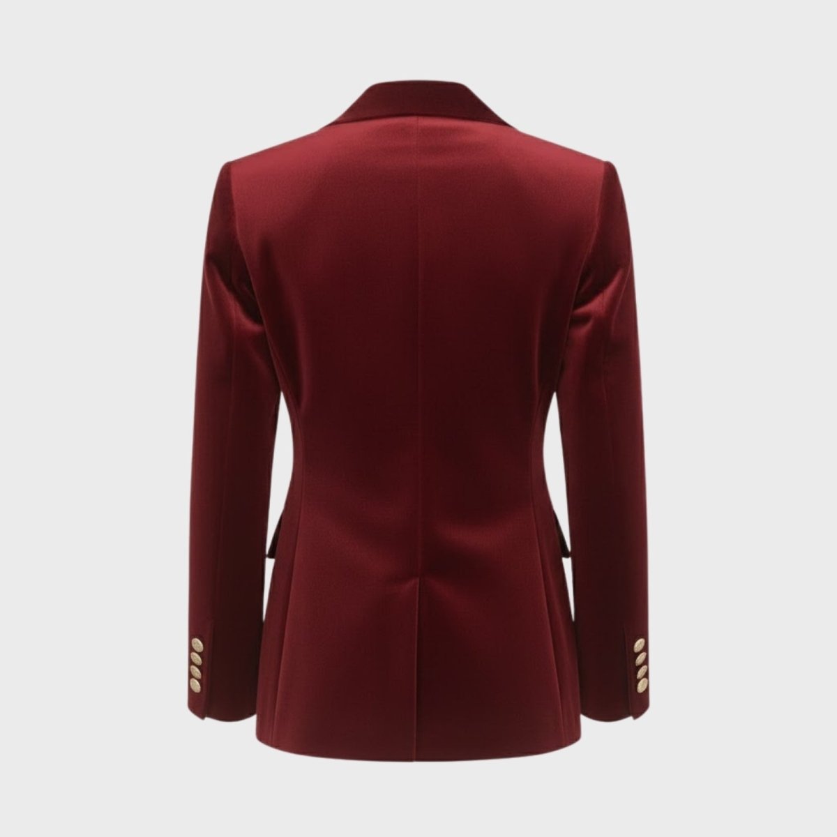 Product detail shot of the back of a luxury red velvet jacket, emphasizing the quality tailoring and construction.