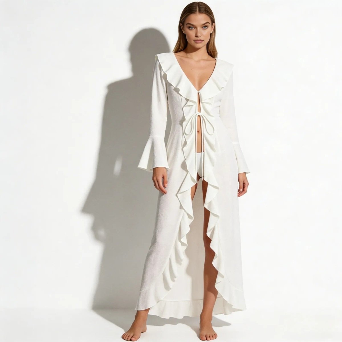 Model wearing the Roseta white ruffle maxi cover up from Kouvr Fashion, shown from the front with tie-front detail.