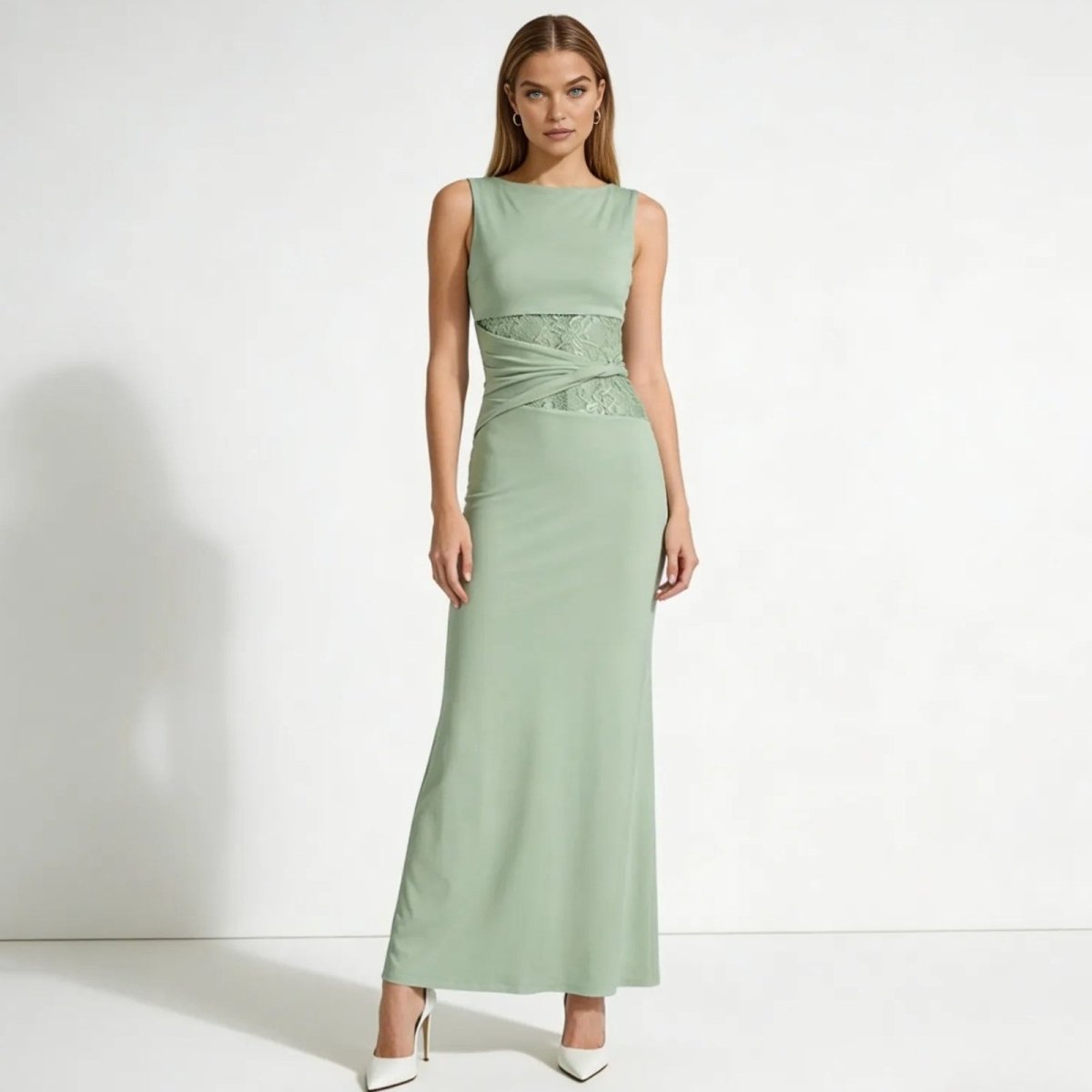 Model wearing the Kouvr Fashion sage green formal maxi dress with lace cutout waist detail, front view.