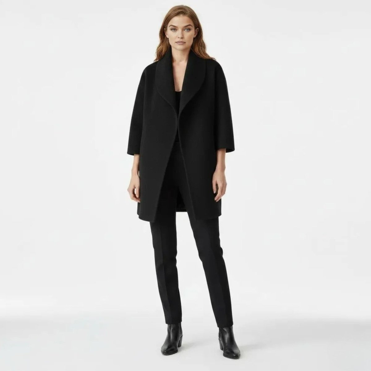Model wearing the Kouvr Fashion black shawl collar wool blend coat, viewed from the front, styled with black trousers and boots.