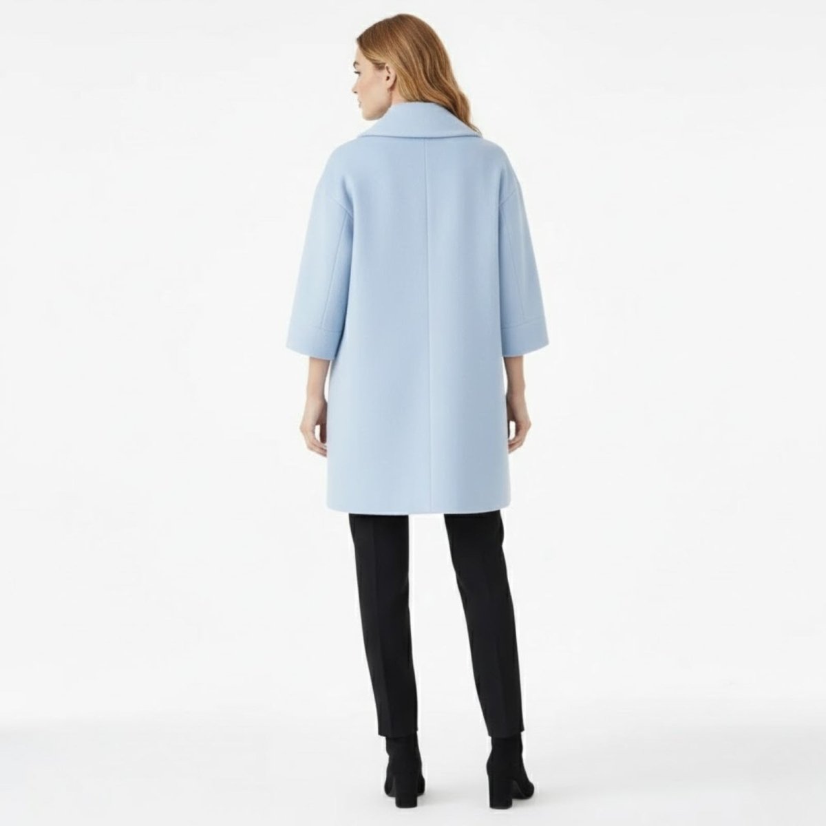 Back view of the sky blue shawl collar coat, showcasing its clean lines and unstructured silhouette on a model.