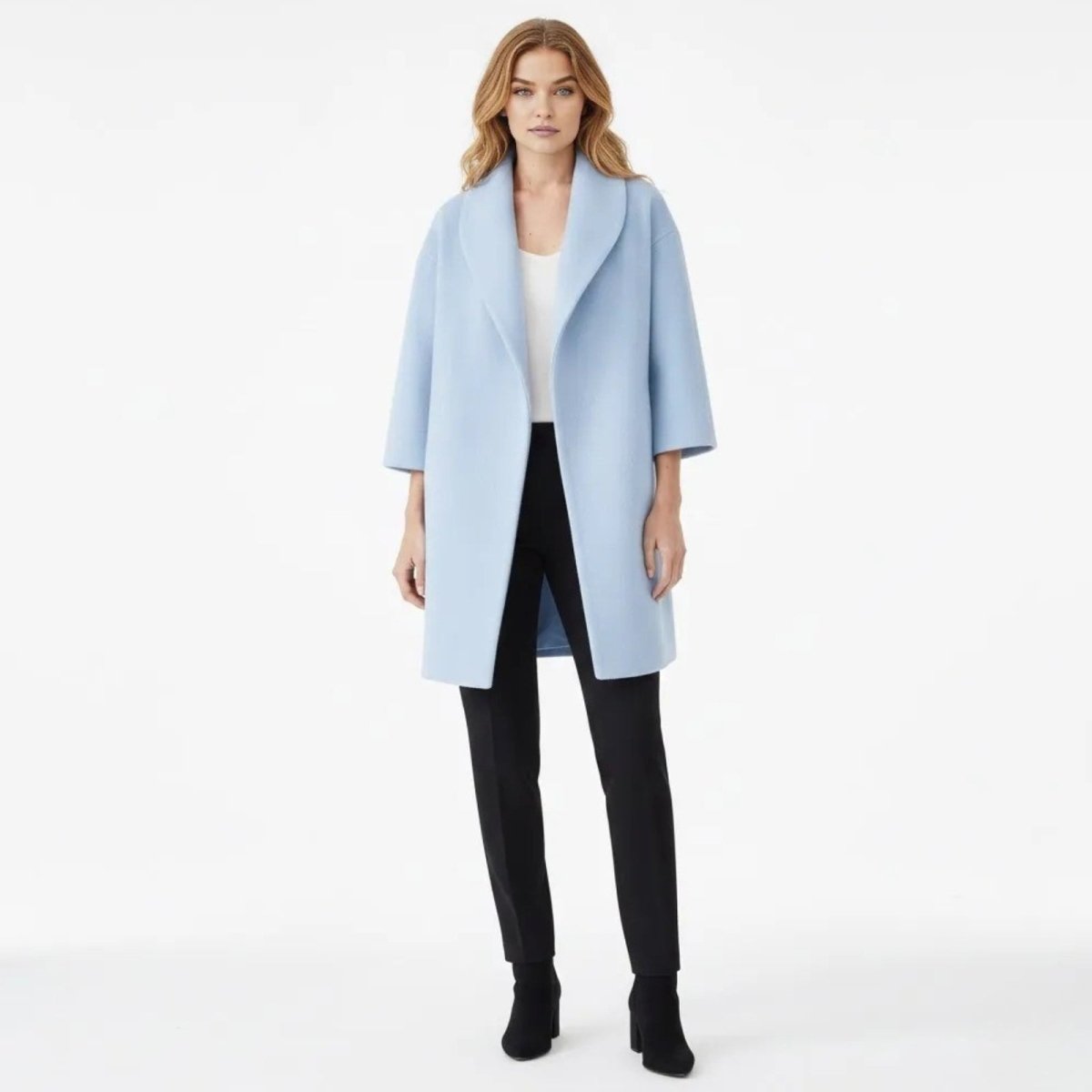 Woman wearing the Kouvr Fashion sky blue wool blend shawl collar coat, styled with black pants and a white top against a white background.