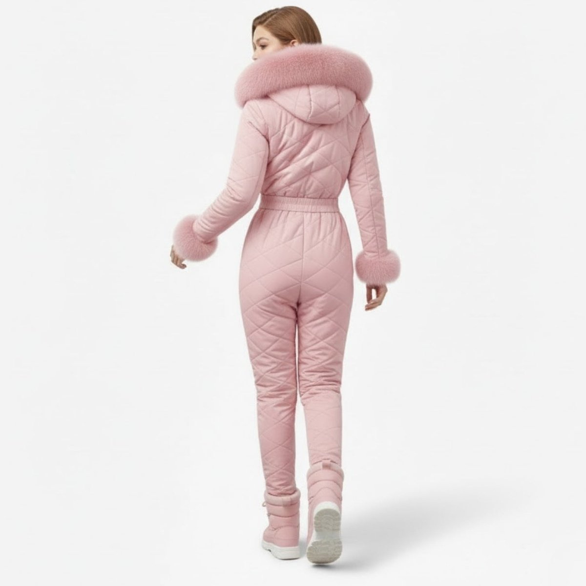 Back view of a model in the Kouvr Fashion Skyla pink ski suit, highlighting the quilted pattern and belted waist.